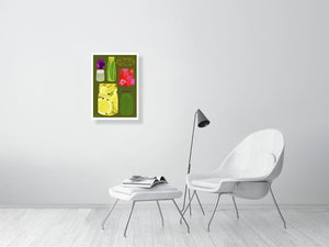 A2 sized pickle print hanging in a living room 